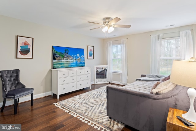 765 Blueberry Ct, Huntingtown, MD 20639 - living room featuring dark wood-type flooring, a healthy amount of sunlight, a ceiling fan, and visible vents