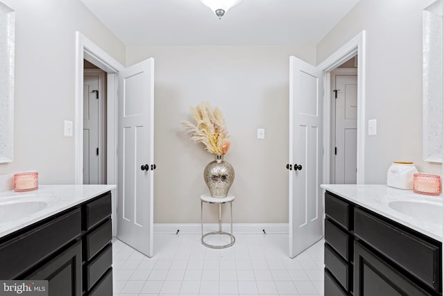 765 Blueberry Ct, Huntingtown, MD 20639 - bathroom with two vanities, baseboards, a sink, and tile patterned flooring