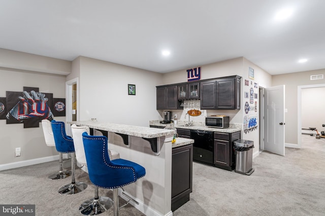 765 Blueberry Ct, Huntingtown, MD 20639 - kitchen featuring stainless steel microwave, a kitchen breakfast bar, light colored carpet, and light countertops