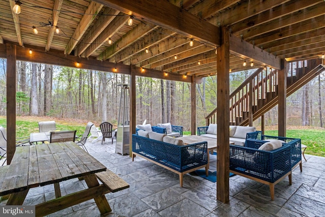 765 Blueberry Ct, Huntingtown, MD 20639 - view of patio featuring a wooded view, outdoor dining space, stairway, and an outdoor hangout area