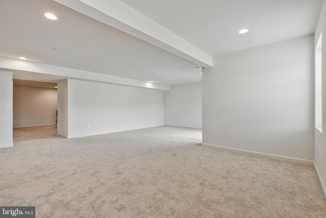 carpeted empty room featuring baseboards and recessed lighting