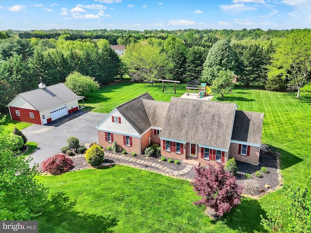 birds eye view of property with a forest view