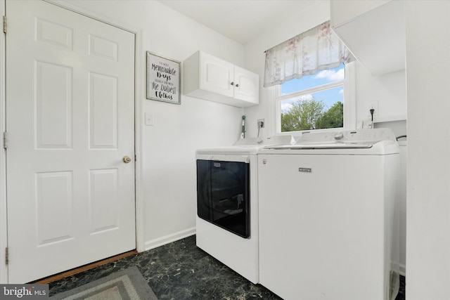 washroom with baseboards, cabinet space, and independent washer and dryer