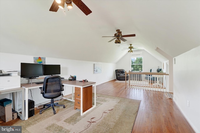 office space with light wood-style floors, baseboards, ceiling fan, and vaulted ceiling