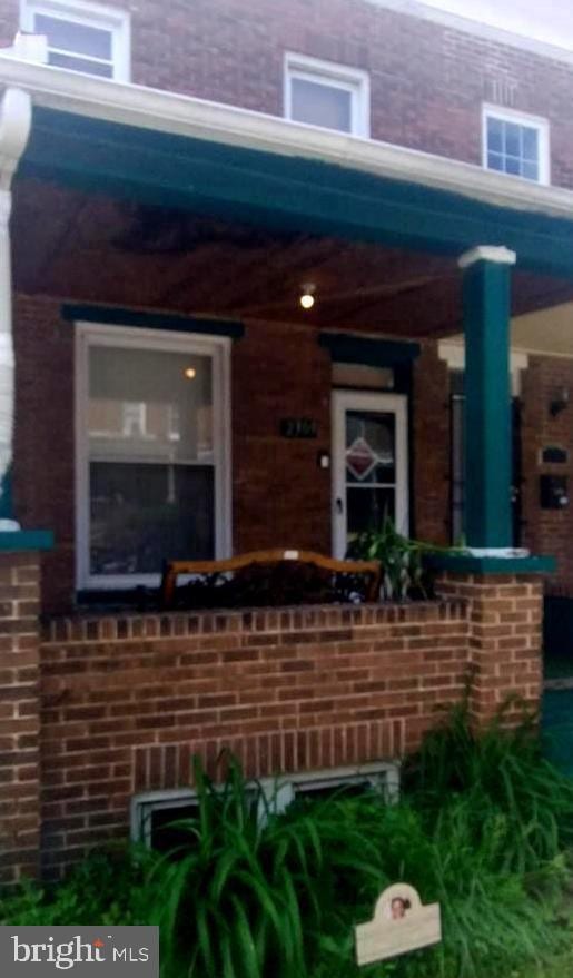 2309 Lauretta Ave, Baltimore, MD 21223 - view of exterior entry featuring brick siding and a porch
