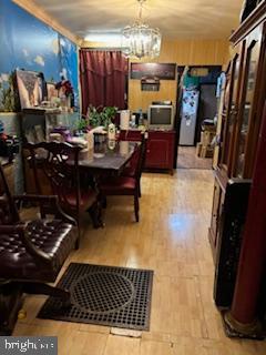2309 Lauretta Ave, Baltimore, MD 21223 - dining space featuring a chandelier and light wood-style floors