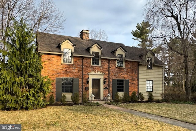 451 E Hamilton Ave, State College, PA 16801 - colonial inspired home featuring roof with shingles, a chimney, a front lawn, and brick siding