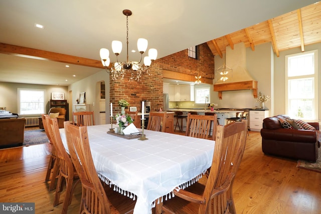 451 E Hamilton Ave, State College, PA 16801 - dining space with lofted ceiling with beams, light wood finished floors, a notable chandelier, and radiator