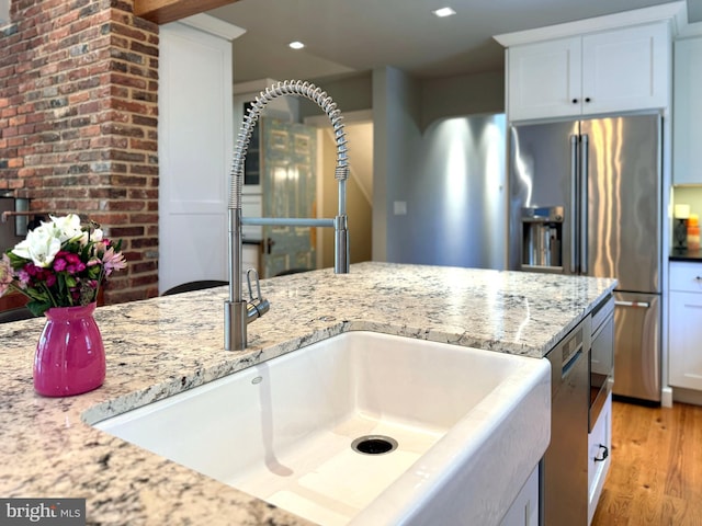 451 E Hamilton Ave, State College, PA 16801 - kitchen featuring a sink, light stone counters, white cabinets, and light wood-style flooring
