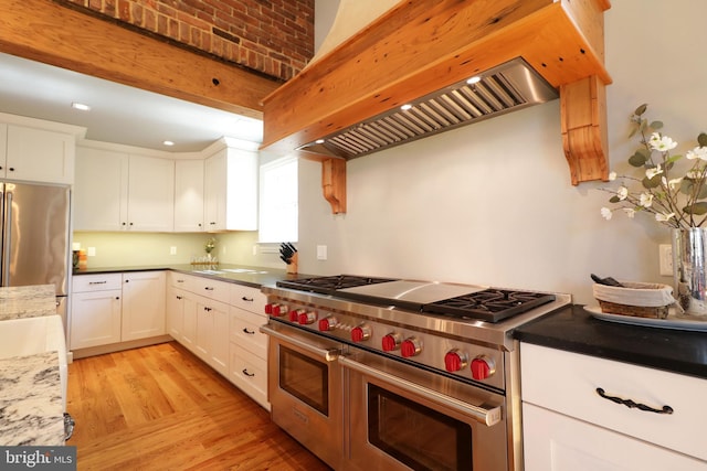 451 E Hamilton Ave, State College, PA 16801 - kitchen with appliances with stainless steel finishes, custom range hood, light wood-style flooring, and white cabinetry