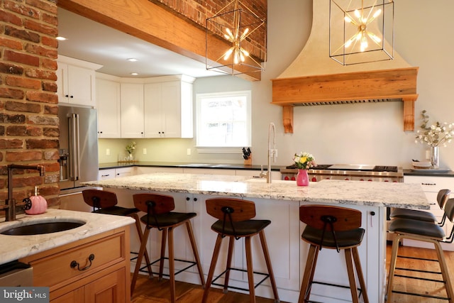 451 E Hamilton Ave, State College, PA 16801 - kitchen with pendant lighting, a sink, premium range hood, a breakfast bar, and high end fridge