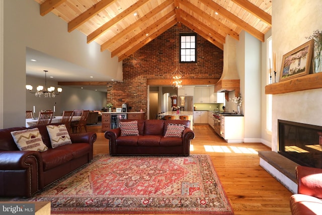 451 E Hamilton Ave, State College, PA 16801 - living room with an inviting chandelier, high vaulted ceiling, a glass covered fireplace, light wood-style flooring, and wooden ceiling