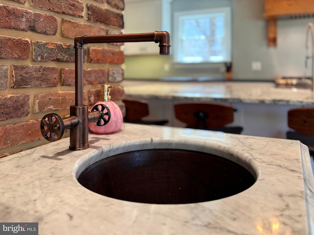 451 E Hamilton Ave, State College, PA 16801 - interior details featuring a sink, a fire pit, and light stone countertops