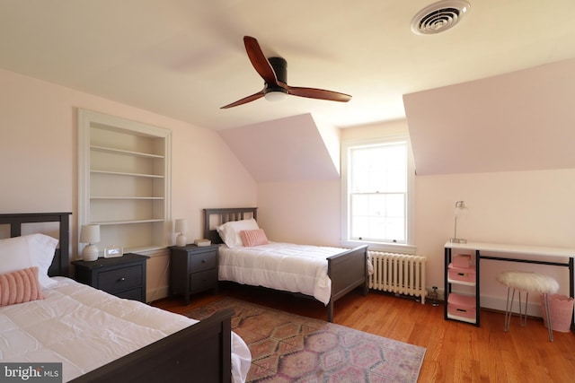 451 E Hamilton Ave, State College, PA 16801 - bedroom featuring visible vents, radiator, lofted ceiling, wood finished floors, and a ceiling fan