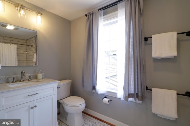 451 E Hamilton Ave, State College, PA 16801 - bathroom featuring toilet, baseboards, and vanity