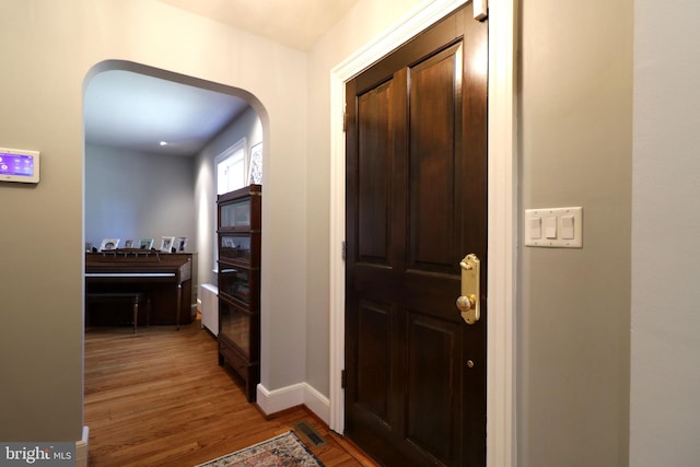 451 E Hamilton Ave, State College, PA 16801 - foyer entrance with arched walkways, baseboards, and light wood finished floors