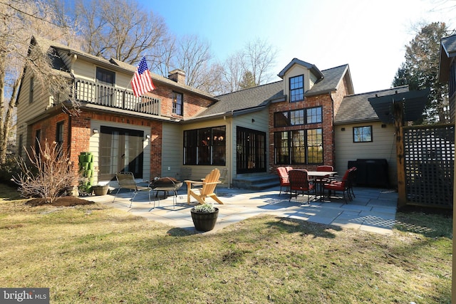451 E Hamilton Ave, State College, PA 16801 - rear view of house featuring brick siding, french doors, a balcony, a lawn, and a patio