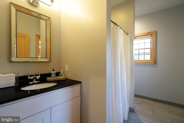 451 E Hamilton Ave, State College, PA 16801 - bathroom featuring vanity, baseboards, curtained shower, and wood finish floors