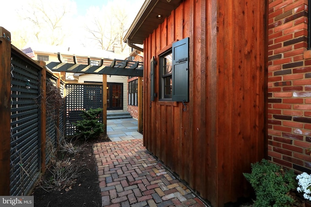 451 E Hamilton Ave, State College, PA 16801 - view of side of home with a patio area, board and batten siding, fence, and a pergola