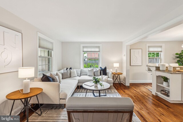 living area featuring dark wood finished floors and baseboards