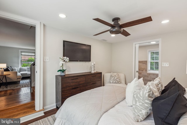 bedroom featuring recessed lighting, wood finished floors, and multiple windows