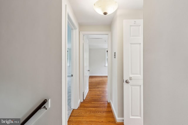 hallway featuring light wood-style floors and an upstairs landing