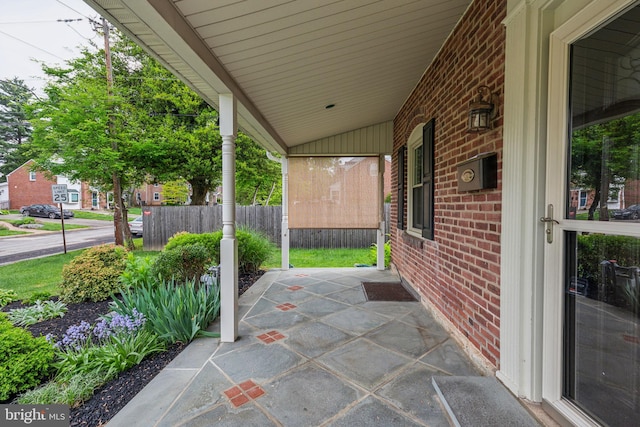 view of patio / terrace with covered porch and fence