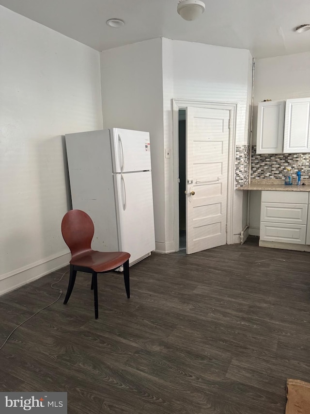 1725 N Creighton St, Philadelphia, PA 19131 - kitchen featuring freestanding refrigerator, light countertops, dark wood-type flooring, and white cabinets