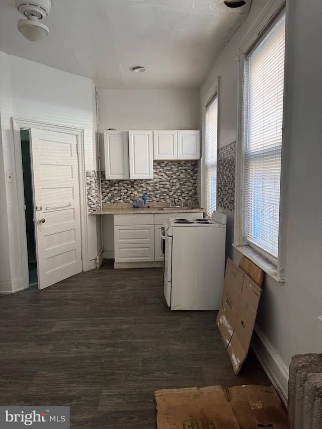 1725 N Creighton St, Philadelphia, PA 19131 - kitchen with white range with electric stovetop, backsplash, light countertops, white cabinets, and dark wood-style floors