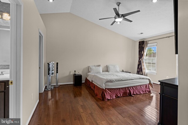 bedroom featuring lofted ceiling, wood finished floors, visible vents, and baseboards