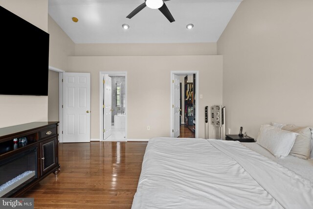 bedroom featuring connected bathroom, a closet, recessed lighting, wood finished floors, and a spacious closet