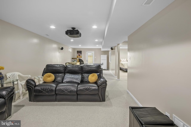 cinema room featuring baseboards, recessed lighting, visible vents, and light colored carpet