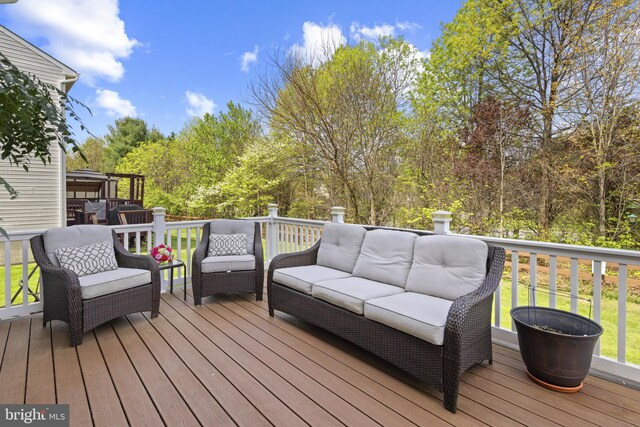 wooden terrace with an outdoor hangout area