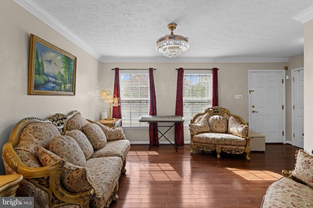living room with a textured ceiling, hardwood / wood-style floors, and ornamental molding