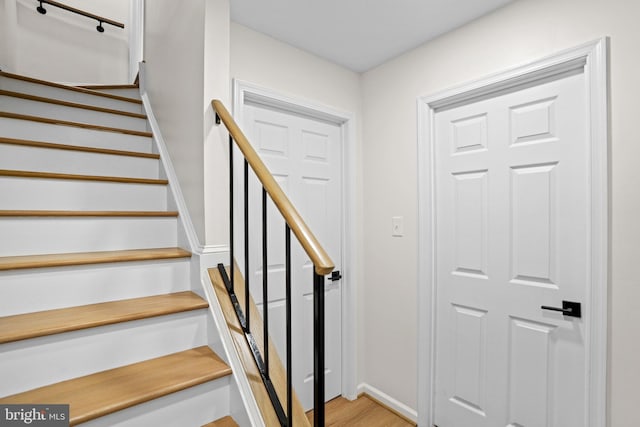 stairs featuring baseboards and wood finished floors