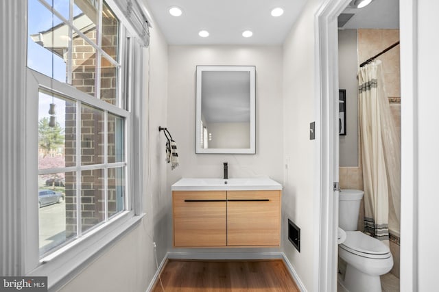 full bath featuring vanity, recessed lighting, toilet, baseboards, and wood finished floors