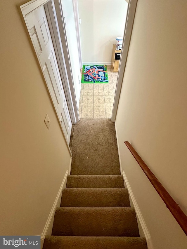 stairs with carpet flooring and baseboards