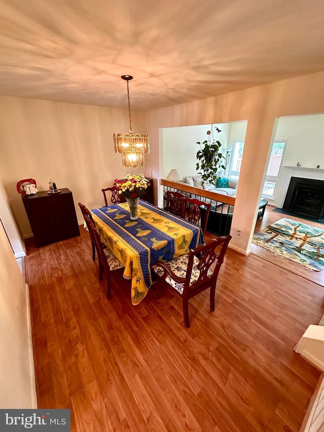 dining area with wood finished floors and a chandelier