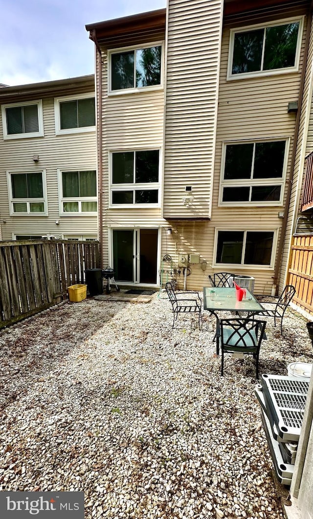 back of property with a fenced backyard and a patio area