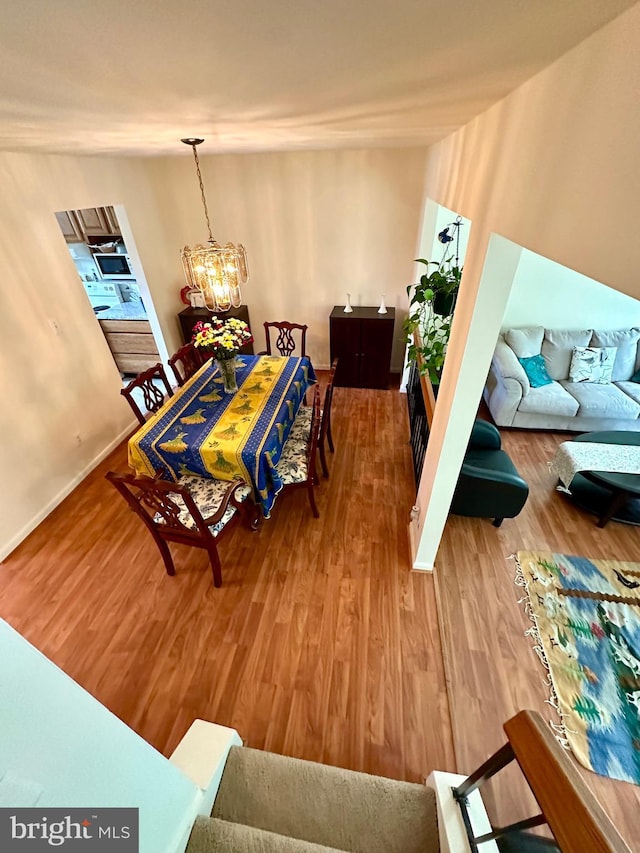 dining area featuring a chandelier and wood finished floors