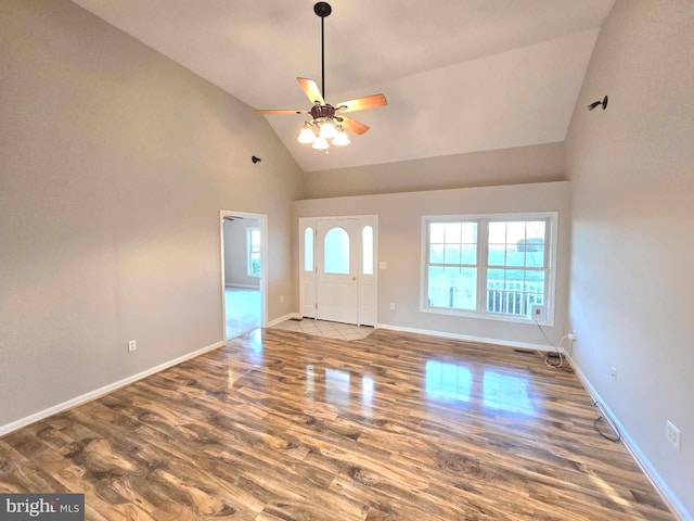 entrance foyer with a ceiling fan, high vaulted ceiling, baseboards, and wood finished floors