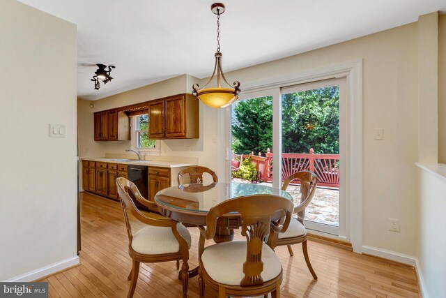 dining room with light wood-style flooring and baseboards
