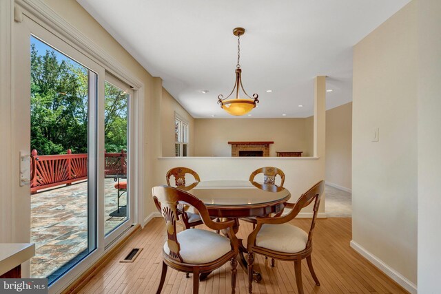 dining area with recessed lighting, visible vents, light wood-style floors, baseboards, and a fireplace
