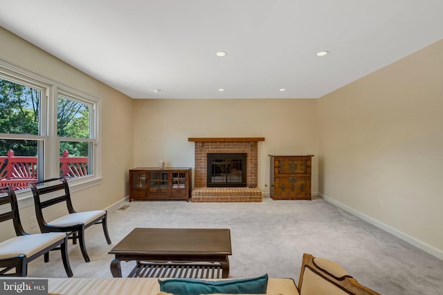 carpeted living area with a brick fireplace, baseboards, and recessed lighting