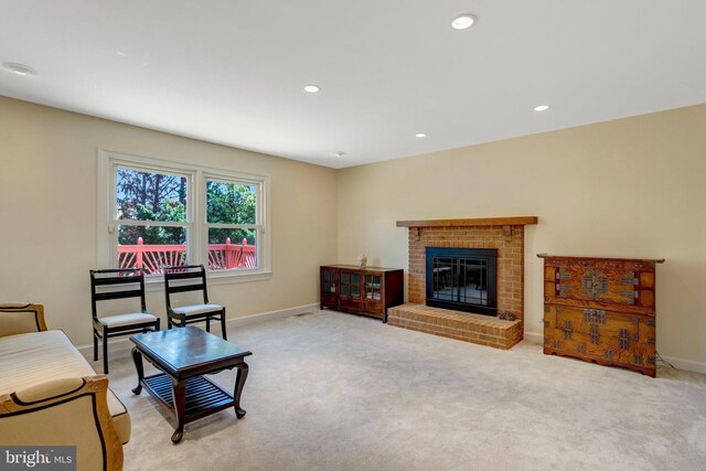 living room featuring recessed lighting, a brick fireplace, carpet flooring, and baseboards