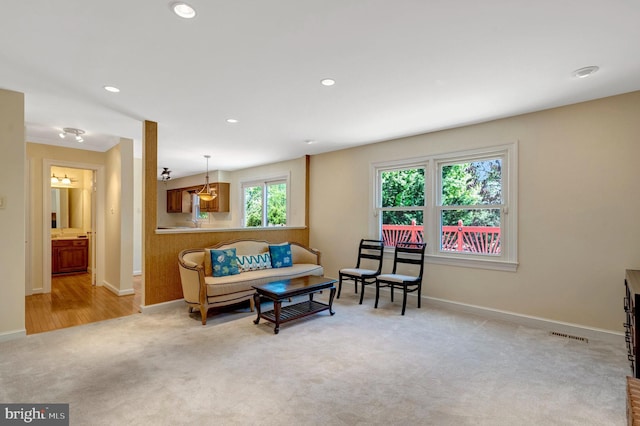 living room featuring recessed lighting, visible vents, baseboards, and light carpet