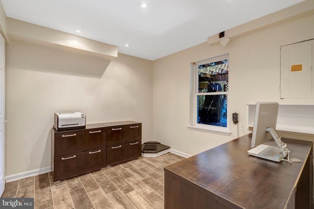 office with recessed lighting, wood finish floors, electric panel, and baseboards