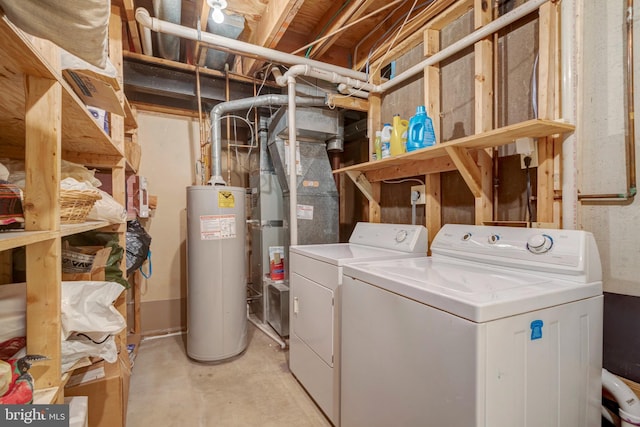 washroom featuring gas water heater, laundry area, and separate washer and dryer