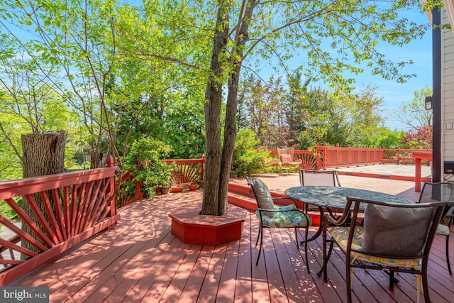 wooden deck featuring outdoor dining space