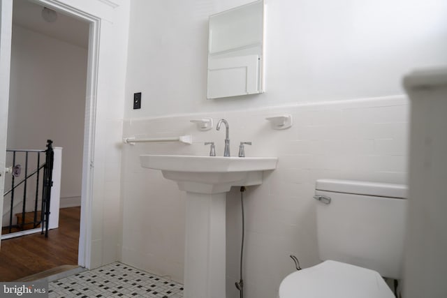 8 Oakley Rd, Upper Darby, PA 19082 - bathroom with wainscoting, tile walls, and wood finished floors